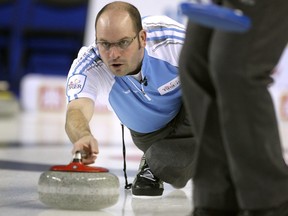 Quebec skip Jean-Michel Menard slid with the rock during the morning draw against Team Canada during the Tim Hortons Brier at the Scotiabank Saddledome in Calgary on March 5, 2015.