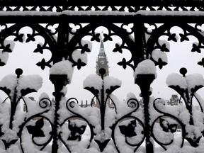 A blanket of snow covers the front gates to Parliament Hill in Ottawa on Wednesday, November 27, 2013., after a major snow storm dropped 20 centimetres of snow on the nation's capital overnight. THE CANADIAN PRESS/Sean Kilpatrick