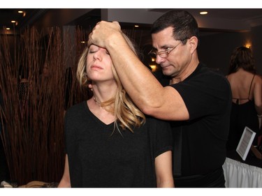 Spa concierge Warren Eaton from Minerva Spa helped Sarah Dumoulin work the kinks out during the Revive Your Style benefit held at the Sala San Marco banquet hall on Sunday, January 31, 2016, for Bust A Move for Breast Health.