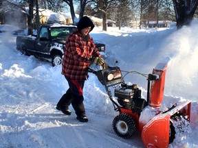Steve Corrigan plows out Soderlind Street in the west end Wednesday morning as the city plow has not been by