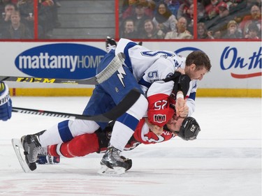 Braydon Coburn #55 of the Tampa Bay Lightning wrestles Chris Neil #25 of the Ottawa Senators to the ice in a second period fight.