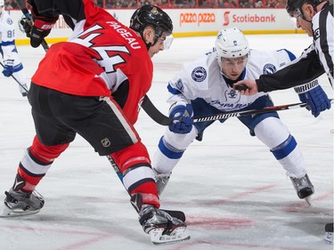Tyler Johnson #9 of the Tampa Bay Lightning prepares for a faceoff against Jean-Gabriel Pageau #44 of the Ottawa Senators.