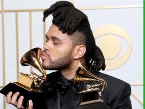 The Weeknd celebrates his success at the Grammy Awards in Los Angeles Monday night.