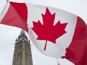 The Canadian flag flies on Parliament Hill.