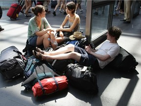 BERLIN - JULY 19:  British backpacker rest prior to their next trip at Hauptbahnhof train station on July 19, 2010 in Berlin, Germany. Millions of youth people taking a gap year between high school and college to see the world. Backpacking is the cheapest way to travel the world.