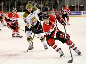 Trent Mallette, right, drives past Steve Harland.