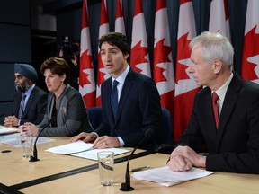 Defence Minister Harjit Sajjan, left to right, International Development Minister Marie-Claude Bibeau, Prime Minister Justin Trudeau and Foreign Affairs Minister Stephane Dion attend a news conference in Ottawa on Monday, Feb. 8, 2016. The Liberal government announced Canada's contribution to the war against the Islamic State of Iraq and the Levant. THE CANADIAN PRESS/Sean Kilpatrick