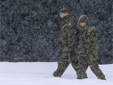 Two members of the Canadian Forces walk along Laurier Avenue.