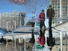 Unseasonably warm temperatures made massive puddles that some tiptoed around and others ploughed through outside Ottawa City Hall next to the Winterlude grounds.