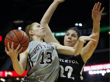 The University of Ottawa Gee-Gees' Catherine Traer shoots over the Carleton Ravens' Heather Lindsay.