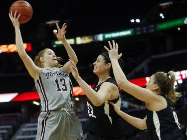 uOttawa Gee-Gees' Catherine Traer, 13, shoots over Carleton University Ravens' Heather Lindsay, 22, and Lindsay Shotbolt, 8.