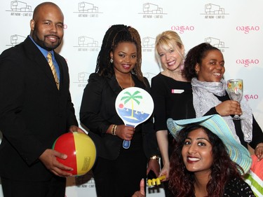 Yuri Hutchinson, chairman of the board for the Caribbean Union of Canada, with its CEO, Prudence Ntaira, OAG director Alexandra Badzak, and Marlie Thomas and Candace Alphonso, also with the Caribbean Union, at On the  Rocks: In the Caribbean, an annual Winterlude party hosted by the Ottawa Art Gallery at City Hall on Friday, February 5, 2016. (Caroline Phillips / Ottawa Citizen)