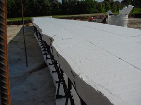 Insulated concrete forms like this use foam to contain wet concrete. The foam is easy to trim so it follows the contours of bedrock.