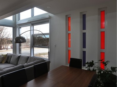Windows are multiple shapes and sizes with an added jolt of colour from two series of translucent strip windows (one series shown here in the dining room).