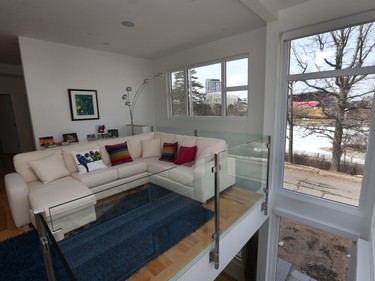 A double-height gap along the windows turns the open family room above the living room into a loft-like space.