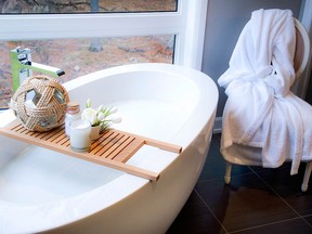 The Wo Wan Bath Shelf teak tub tray keeps calming items close at hand, including Rue de Marli bath salts and a votive candle, sold at Astro Design Centre and Terra20, and Zodax Abarca glass rope ball (zodax.com).