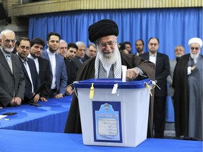 In this Friday, Feb. 26, 2016 file photo, released by official website of the office of the Iranian supreme leader, Supreme Leader Ayatollah Ali Khamenei casts his ballot during parliamentary and Experts Assembly elections in Tehran, Iran.