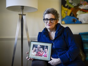 Amy Desjardins sits at her home holding the photo of her mother and sisters on March 11, 2016. Amy's sister Hiranmoyi Elliott passed away while receiving palliative care at May Court Hospice.