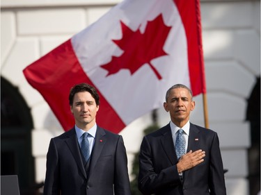 President Barack Obama and Canadian Prime Minister Justin Trudeau, stand for the playing of national anthems during an arrival ceremony on the South Lawn of the White House in Washington, Thursday, March 10, 2016.