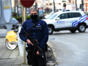 A police officer patrols near a tramway train after it was evacuated during an anti-terrorist operation in the Schaerbeek - Schaarbeel district in Brussels on March 25, 2016. Belgian police carrying out a fresh anti-terrorist operation today arrested a suspect, who suffered a slight injury, Schaerbeek Mayor Bernard Clerfayt told AFP. Police sources said the operation was connected to a foiled terror plot in France.  /