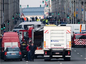 A picture taken on March 22, 2016 shows Belgian police and emergency staff arriving in the Wetstraat - Rue de la Loi, which has been evacuated after an explosion at the Maelbeek metro station  in Brussels.