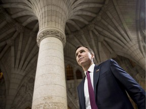 Minister of Finance Bill Morneau walks through the rotunda as he participates in TV interviews after tabling the federal budget on Parliament Hill in Ottawa.