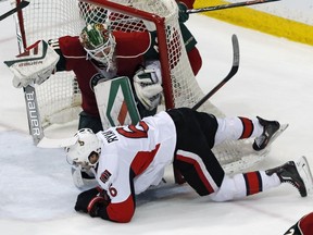 Ottawa Senators' Bobby Ryan, bottom, falls after hitting the net which tilts over Minnesota Wild goalie Devan Dubnyk in the first period of an NHL hockey game Thursday, March 31, 2016, in St. Paul, Minn.