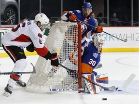 Ottawa Senators right wing Bobby Ryan (6) tries to score as New York Islanders goalie Jean-Francois Berube (30) deflects the puck and New York Islanders defenseman Calvin de Haan (44) reacts opposite the net in the first period of an NHL hockey game in New York, Wednesday, March 23, 2016. The Islanders defeated the Senators 3-1.