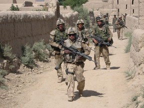 Canadian troops from 9 Platoon, C Company, PPCLI, patrol Afghan village of Zangadin for Taliban, on June 14, 2006.