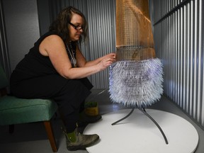 Charlynne Lafontaine from Loretta Studios and Gallery works on glass fur coat which will be featured in a fashion show at Corning Museum of Glass during Artspace613 self storage art show held at Just Right Self Storage on Saturday, March 26, 2016.