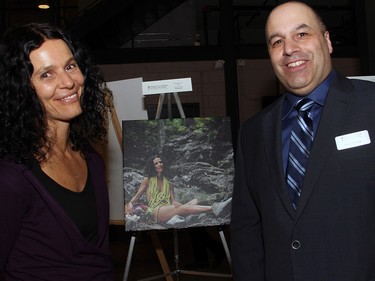 Chef Natasha Kyssa from Simply Raw Express, seen with the Shepherds of Good Hope communications manager Don Ermen, poses with a photo of her that's featured in a new calendar of local chefs, unveiled Wednesday, March 30, 2016, during the A Taste For Life culinary event for the Shepherds of Good Hope.