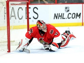 Craig Anderson grimaces in pain as he tries to get to his feet in the second period as the Ottawa Senators take on the St Louis Blues in NHL action at the Canadian Tire Centre.