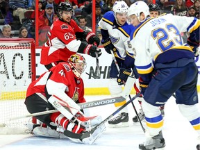 Craig Anderson grimaces in pain making a stop in the second period as the Ottawa Senators take on the St Louis Blues in NHL action at the Canadian Tire Centre.
