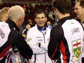 Craig Savill, middle, enjoys a laugh with Glenn Howard, left, Joey Hart, second from right, and Richard Hart, right, of Team Ontario at the Brier in Ottawa on Thursday, March 10, 2016.