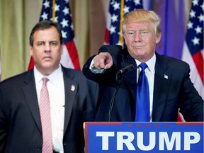Republican presidential candidate Donald Trump, accompanied by New Jersey Gov. Chris Christie, left, takes questions from members of the media during a news conference on Super Tuesday primary election night in the White and Gold Ballroom at The Mar-A-Lago Club in Palm Beach, Fla., Tuesday, March 1, 2016.