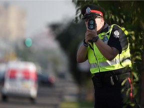 Cst. Andrew Kirby uses laser radar at a speed trap set up in Edmonton on Thursday Aug. 13, 2105.