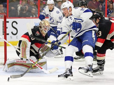 Erik Condra drives to the net but is stopped by Andrew Hammond and Nick Paul (R) in the second period as the Ottawa Senators take on the Tampa Bay Lightning in NHL action at the Canadian Tire Centre in Ottawa.