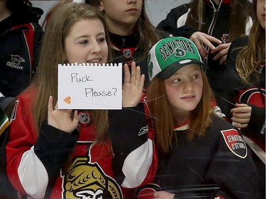 Two young fans make a request of the Sens players.