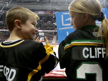 Two young fans check out a photographed memory.
