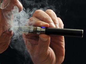 In this file picture, a smoker demonstrates an e-cigarette.