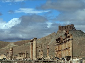 (FILES) This file photo taken on March 14, 2014 shows Palmyra castle (citadel) on a hilltop and a partial view of the ancient oasis city of Palmyra, some 215 kilometres northeast of Damascus.