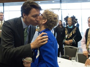 Prime Minister Justin Trudeau, left, gives Ontario Premier Kathleen Wynne a kiss as he arrives for a meeting of the First Ministers, First Nations, Inuit, and Metis Leaders in Vancouver, B.C., Wednesday, March. 2, 2016. THE CANADIAN PRESS/Jonathan Hayward ORG XMIT: JOHV132