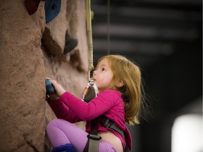 Four year old Katie Knatyshyn tries out Altitude Rock Climbing Gym's climbing wall at the fifth annual Ottawa Outdoor Adventure Travel Show at the EY Centre on Saturday, March 19, 2016.