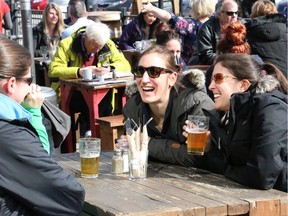 Friends enjoy the warm weather and a beer at the Lowertown Brewery in the ByWard Market on Sunday, March 13, 2016.
