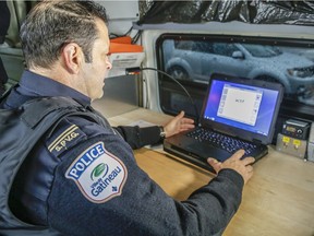 Gatineau Police Sgt. spokesperson J.P. Lemay monitors vehicles with photoradar from a van at a school zone outside L'Ecole de l'Odysee Wednesday, March 9, 2016.