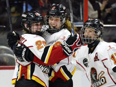 Calgary Inferno's Jessica Campbell (20) celebrates her goal against Les Canadiennes de Montreal with teammates Sarah Davis (9) and Bailey Bram (17) during the second period of Canadian Women's Hockey League final action at the Clarkson Cup, Sunday March 13, 2016, in Ottawa.