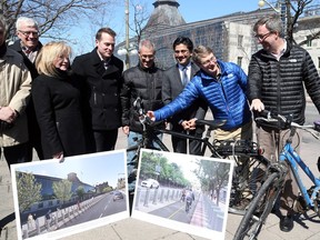 Jim Watson (R) and David Chernushenko (2nd from R) try out the bells on bikes after Yasir Naqvi's announcement of new funds for Ottawa bicycle lane program, March 29, 2016.