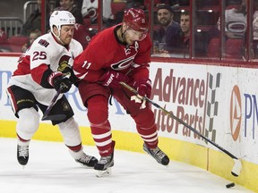 Carolina Hurricanes' Jordan Staal (11) handles the puck as Ottawa Senators' Chris Neil (25) follows during the first period of an NHL hockey game in Raleigh, N.C., Tuesday, March 8, 2016.