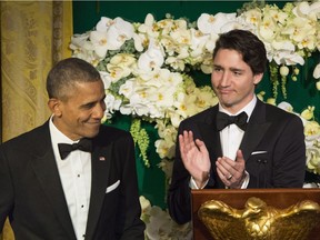 Prime Minister Justin Trudeau applauds U.S. President Barack Obama during a state dinner Thursday, March 10, 2016 in Washington.
