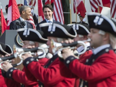 Canadian Prime Minister Justin Trudeau, right, and U.S. President Barack Obama share a laugh at a state arrival ceremony on the South Lawn of the White House in Washington, D.C., on Thursday, March 10, 2016.